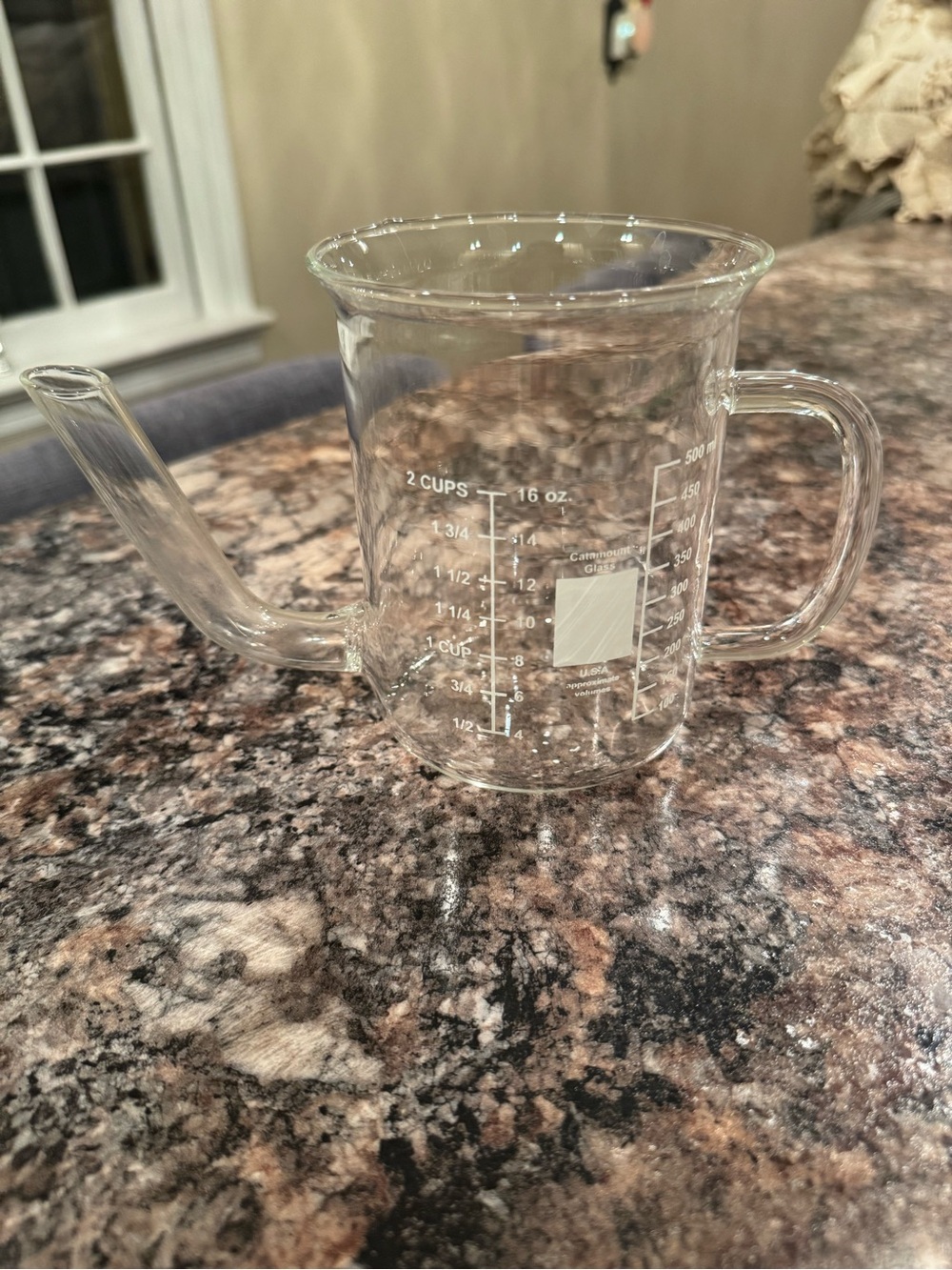 A Catamount Glass USA 500ml laboratory beaker with handle and spout